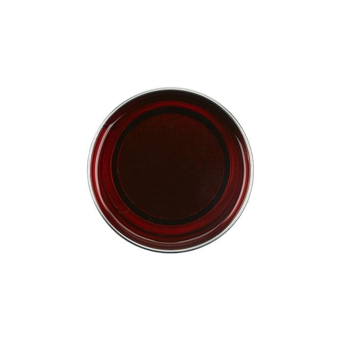 Top view of a glass filled with red wine against a white background, reflecting the elegance and simplicity akin to GiGi All Purpose Hard Wax 0332.