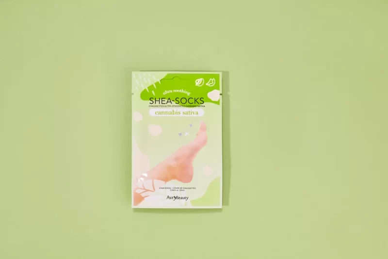 A package of AvryBeauty CBD Gloves Single on a green background.