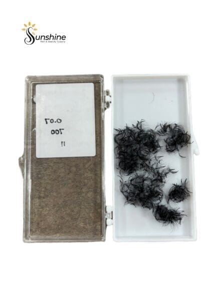 A box of ROYAL LASHES 7D Pre-Made Fan Individual Lash 0.07 (700pcs) in a plastic container.