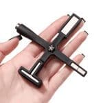 A hand holding a Multifunctional Cat Eye Magnet Stick with multiple socket heads.