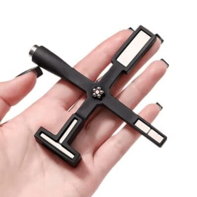 A hand holding a Multifunctional Cat Eye Magnet Stick with multiple socket heads.