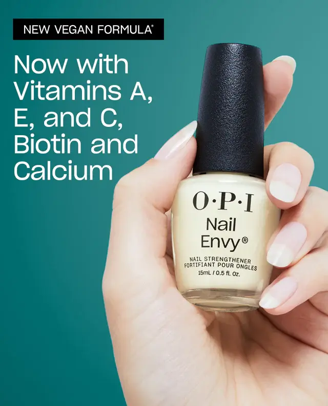 A hand holding a bottle of OPI Nail Envy Tri-Flex Technology 0.5oz, featuring a new vegan formula containing vitamin E, A, biotin.