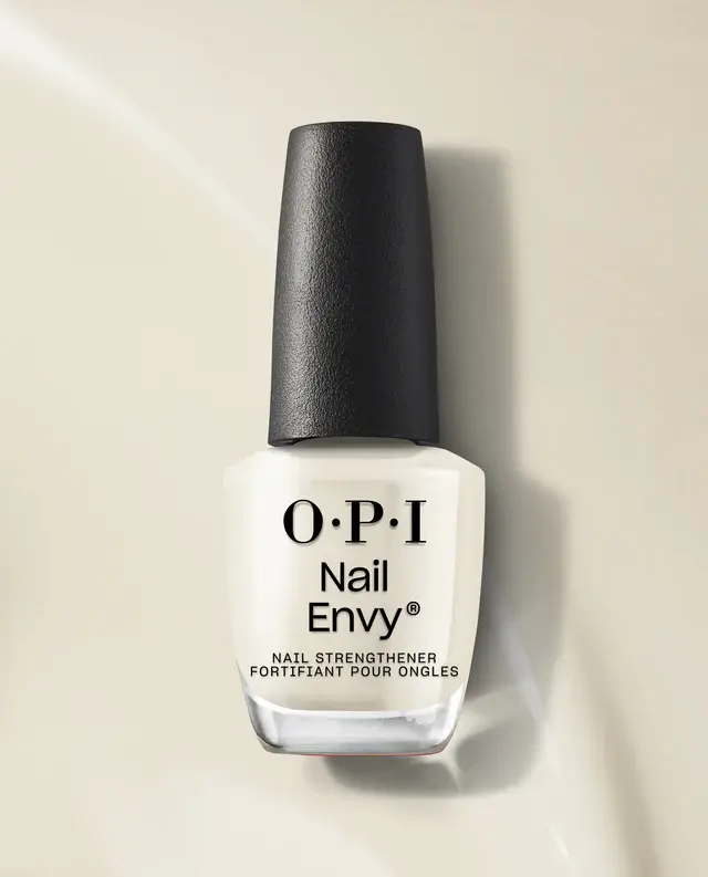 A bottle of OPI Nail Envy Tri-Flex Technology 0.5oz on a beige surface.