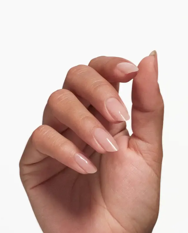 A well-manicured hand with pale pink nails, courtesy of OPI Nail Envy Tri-Flex Technology 0.5oz, against a white background.