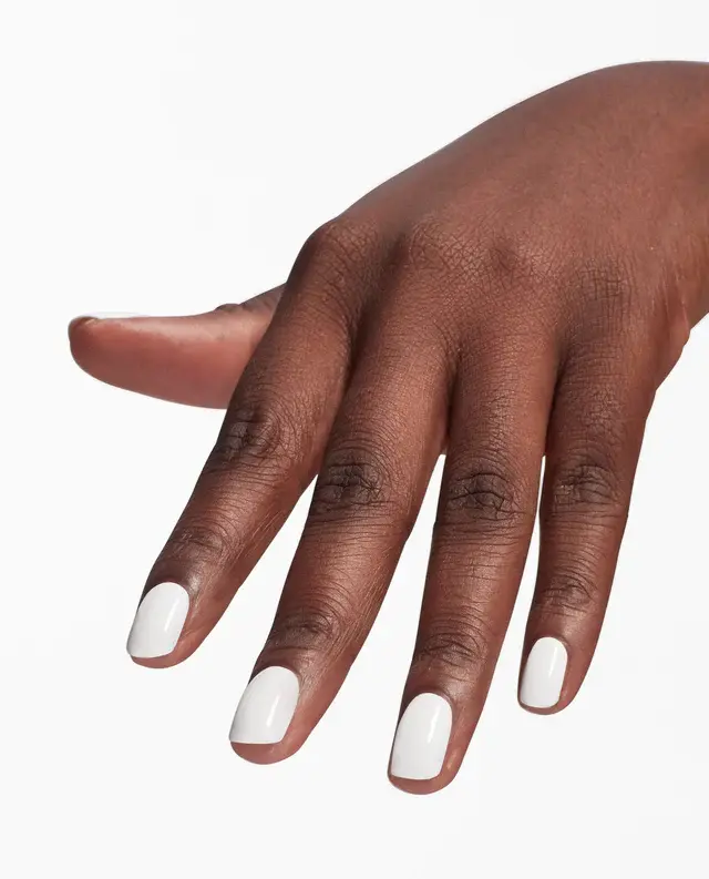 A person's hand with white polished nails enhanced by OPI Nail Envy Tri-Flex Technology 0.5oz against a white background.