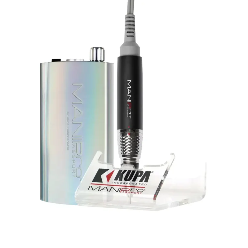 An electric nail file with a clear handpiece cradle, connected to a compact, metallic control unit labeled "MANIPRO Passport Complete Unicorn" by Kupa.