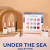 A display of LAVIS nail polish bottles and a sample sheet labeled "LAVIS Cat Eye CE2 - Under The Sea Collection" featuring the mesmerizing Cat Eye CE2 color among other vibrant shades is elegantly arranged on a table.