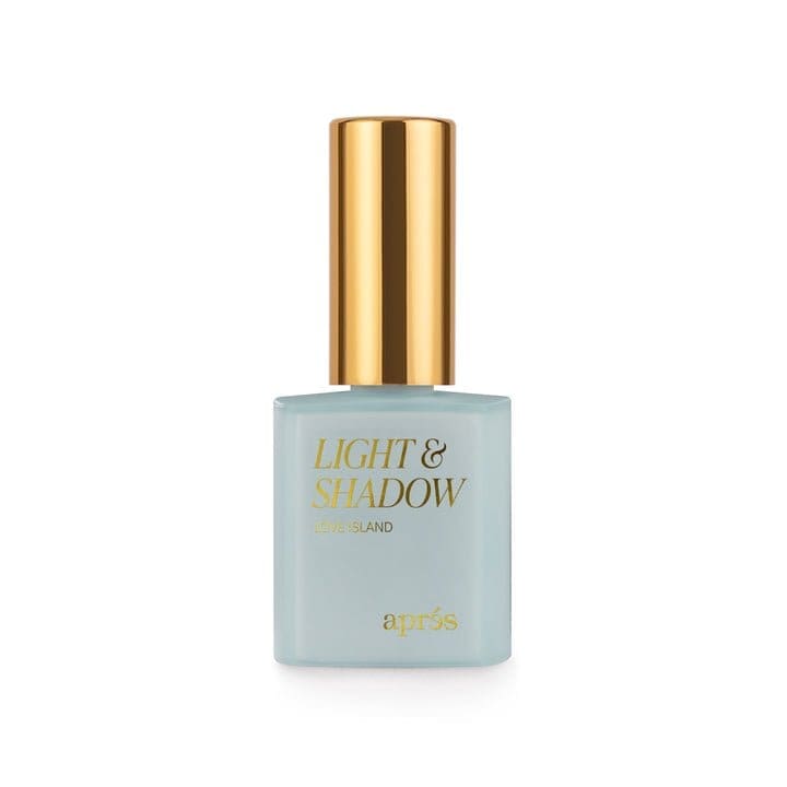 Nail polish bottle with a gold cap. The bottle is labeled "Apres Light & Shadow Sheer Gel Collection 10ml." The bottle is light blue in color.