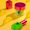 Brightly colored Nitro VIBE Collection 3-in-1 Powder, Gel, & Lacquer (24 Colors) bottles and a jar on a yellow background, surrounded by lemon wedges. One Nitro VIBE bottle and jar are pink with green accents; the other bottle is green with a pink cap.