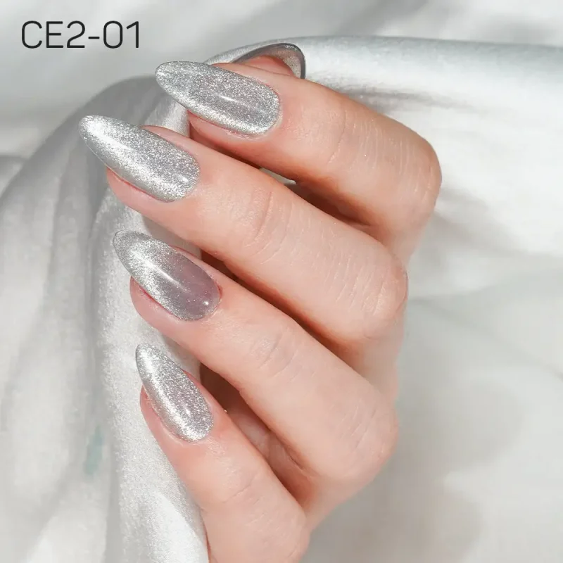 A hand with long, almond-shaped nails painted in metallic silver polish from the LAVIS Cat Eye CE2 - Under The Sea Collection. The hand is resting on a white, silky fabric. The text "CE2-01" is visible in the top left corner.