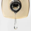 Close-up of a translucent liquid droplet of Apres Extend Gel Non-Wipe 15ml hanging from the nozzle of a 15ml bottle against a plain background.