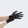 A person is shown putting on a black BLUZEN Nitrile Gloves Extra Strength (10box/cs) on their right hand, with both gloves being made of a smooth material for extra strength.