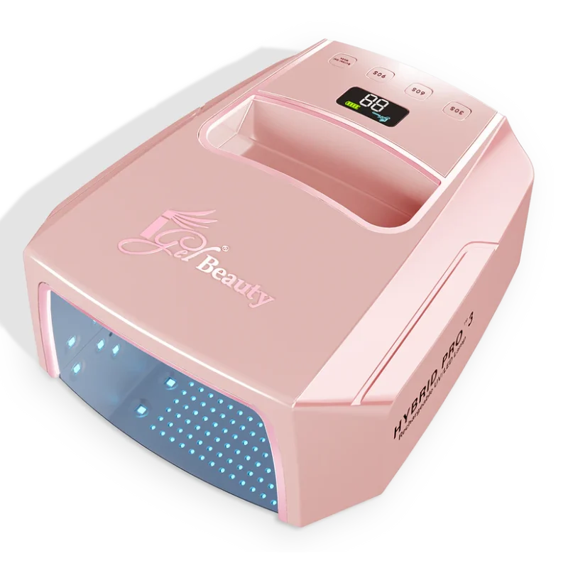 The pink iGel Hybrid Pro 3.0 Wireless Rechargeable UV/LED Lamp features a digital display, buttons on top, and an opening with blue LED lights for curing gel nails. This UV/LED Lamp is also wireless rechargeable for added convenience.