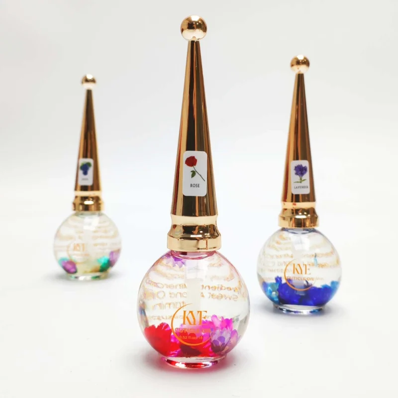 Three conical-capped, round glass bottles are displayed, each containing colorful KYE Flower Cuticle Oil 0.9oz and labeled with different floral designs—rose, lavender, and an unknown flower. Each bottle holds 0.9oz of botanical bliss by KYE.