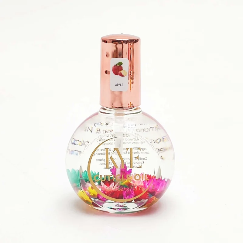 A round glass perfume bottle with a metallic cap, labeled "Apple," containing 0.9oz of liquid and colorful flower petals inside—perfectly embodying the essence of KYE Flower Cuticle Oil 0.9oz.