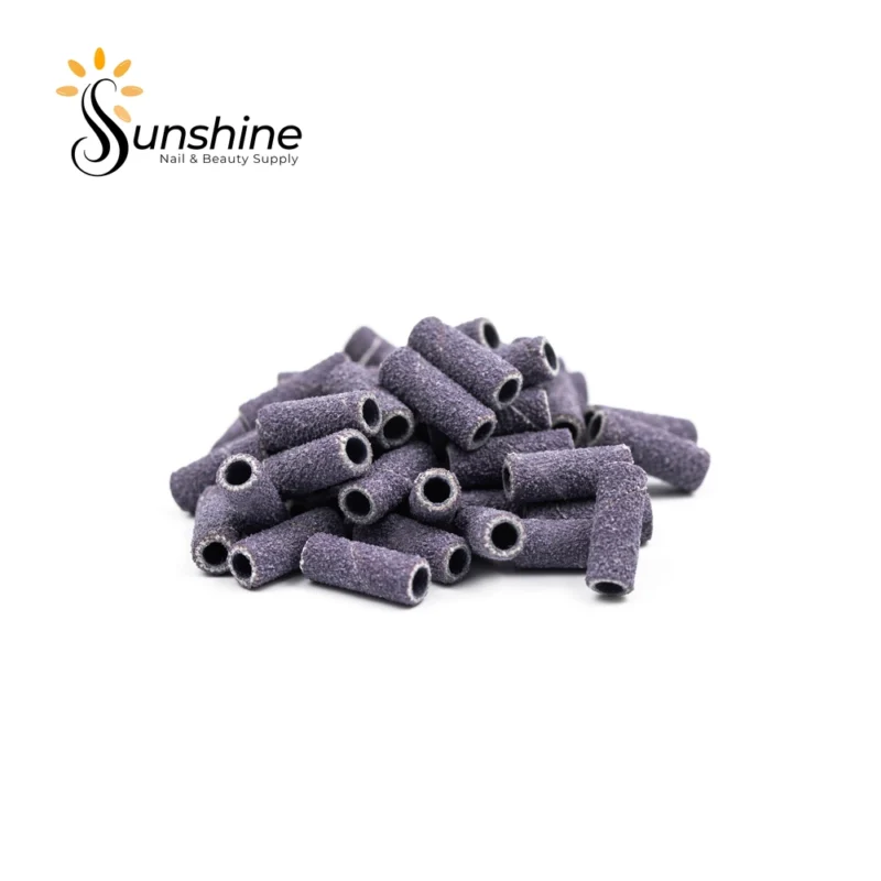 A pile of cylindrical sanding bands with a rough texture, used for nail and beauty care. Logo of Sunshine Nail & Beauty Supply is displayed in the top left corner. Each KYE Small Premium Grade 3M Purple Sanding Band 50pcs/Box comes in a set, ensuring you have plenty for multiple sessions.