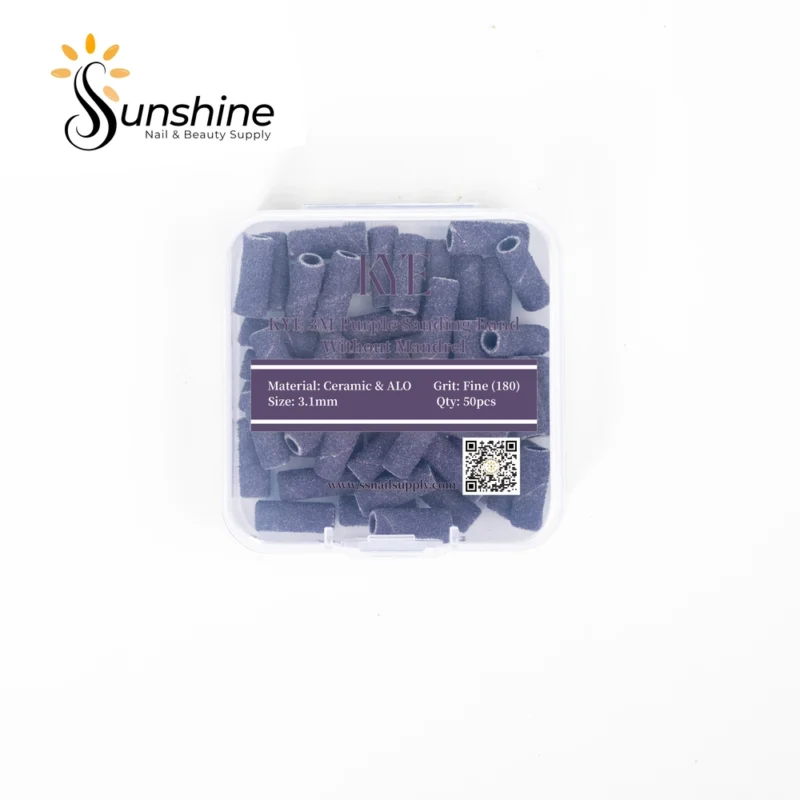 A clear plastic container labeled "KYE Small Premium Grade 3M Purple Sanding Band 50pcs/Box" holds 50 pcs of small premium grade abrasive sanding bands for nail care. The label details: Material - Ceramic & ALO, Grit - Fine (180), Size - 3.1mm.