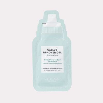 A labeled packet of Voesh Callus Remover Gel Aloe Extract & Olive Oil Single Pack, designed to break down calluses in minutes. The light blue packet features a white cap.