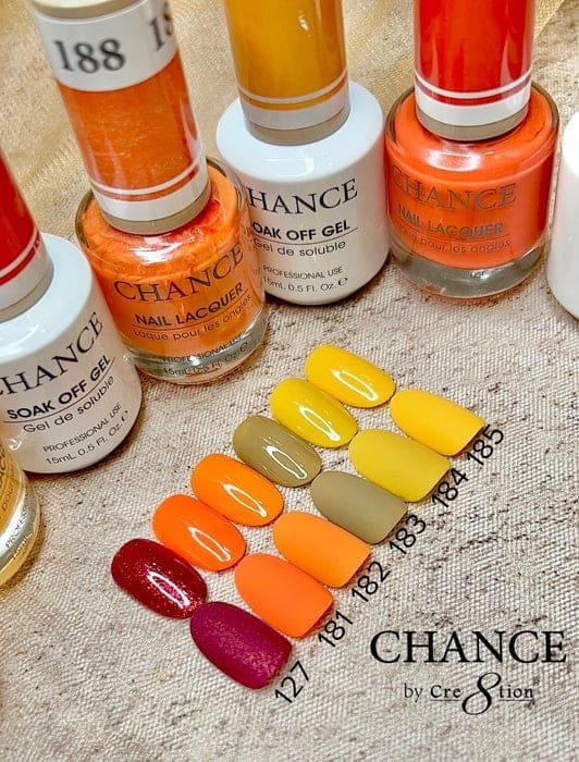 A set of CHANCE Matching Trio nail polish bottles, part of the Hello Autumn Collection, features a variety of gel colors displayed on nails. The collection includes 36 vibrant shades ranging from deep red to bright yellow, each identified by numbers from 127 to 188.