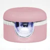 A pink, rounded container with a transparent window and metallic accent in the middle, ideal for your Gelish Solid Cream Gel Polish Starter Kit - BLUSH.