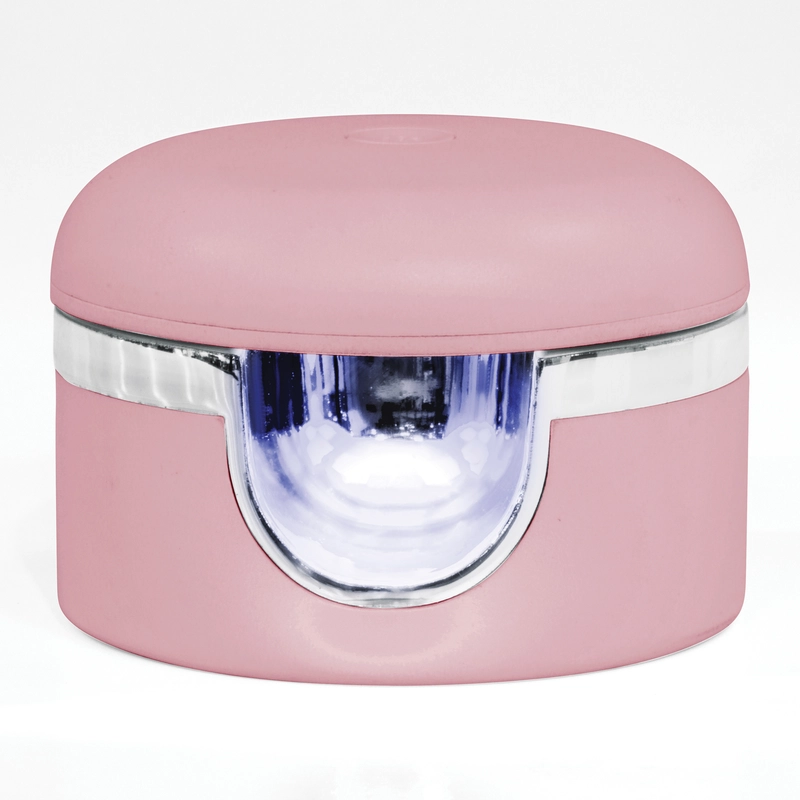 A pink, rounded container with a transparent window and metallic accent in the middle, ideal for your Gelish Solid Cream Gel Polish Starter Kit - BLUSH.