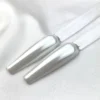 Two nail polish sample sticks with a glossy Cre8tion White Silk Chrome Nail Art Effect 1g finish are displayed on a luxurious white fabric background, perfect for showcasing exquisite Nail Art.