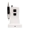 The ManiPro Passport Next Complete White, a sleek white dental handpiece with a black handle, rests elegantly on its charging base.