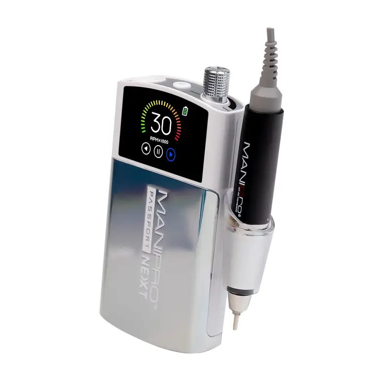 A silver and white portable nail drill machine with a corded handpiece, the ManiPro Passport Next Complete White features a digital display showing "30" on its screen and is labeled "MANI PRO PASSPORT NEXT.