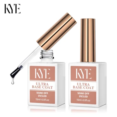 Two bottles of KYE Rubber Base 0.5oz, featuring rose gold caps, stand elegantly. One bottle is open, displaying a brush applicator above it. This base coat is formulated without HEMA to ensure a flawless finish every time.