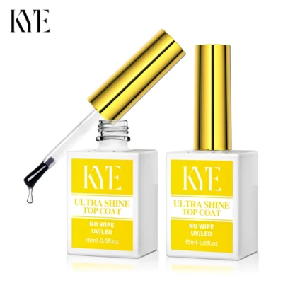 Two bottles of KYE Ultra Shine Top Coat are displayed, with one open to show the brush and a glistening drop of liquid. The labels read "No Wipe UV/LED, 15ml-0.5oz," and they feature gold caps. This top coat is designed to pair seamlessly with the KYE Rubber Base 0.5oz (NO HEMA) for safer use.