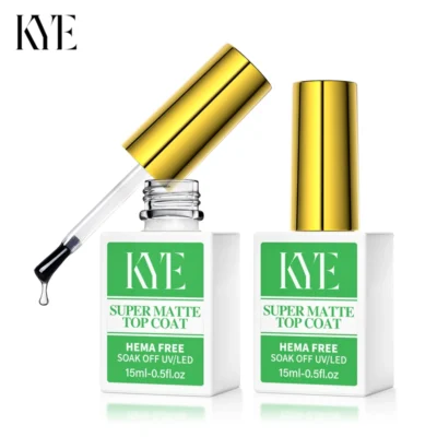 Two bottles of KYE Rubber Base 0.5oz, topped with elegant gold caps, display their sophistication; one is open with a brush gently poised and a drop of liquid gleaming. These formulas ensure flawless finishes every time, proudly featuring NO HEMA for safer application.